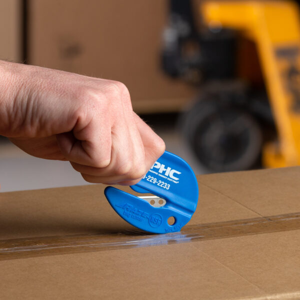 Close-up shot of someone using the built-in tape splitter on the blue Raze bag cutter.